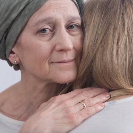 cancer-woman-hugging-young-girl-2023-11-27-05-05-56-utc